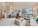 Inviting living room featuring neutral tones, plush seating, and large windows, offering ample natural light and a welcoming atmosphere at 3546 Broadlands Ln # 102, Broomfield, CO 80023