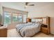 Bright main bedroom with windows, neutral tones, and a mirrored dresser, creating a peaceful and airy ambiance at 3546 Broadlands Ln # 102, Broomfield, CO 80023