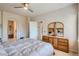 Comfortable main bedroom with a ceiling fan, ensuite access, and large dresser, providing a relaxing retreat at 3546 Broadlands Ln # 102, Broomfield, CO 80023
