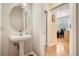 This powder room features a pedestal sink and is conveniently located near the entryway at 3546 Broadlands Ln # 102, Broomfield, CO 80023