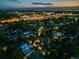 Aerial view of neighborhood at night, showing city lights, mature trees, and skyline at 1609 S Clayton St, Denver, CO 80210
