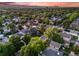 Aerial daytime view of neighborhood showing mature trees, manicured lawns, and mountain backdrop at 1609 S Clayton St, Denver, CO 80210