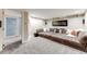 Basement media room with a large sectional sofa and carpeted floors at 1609 S Clayton St, Denver, CO 80210