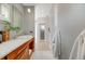 Elegant bathroom with wood vanity, marble countertops, vessel sink, and modern fixtures at 1609 S Clayton St, Denver, CO 80210