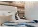 Cozy bedroom showcasing wood paneling behind the headboard, complemented by a stylish chandelier at 1609 S Clayton St, Denver, CO 80210