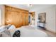 Cozy bedroom with wood paneled wall, built in shelving, and a comfortable bed at 1609 S Clayton St, Denver, CO 80210