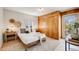 Bedroom featuring neutral tones, wood floors, and a view of the pool at 1609 S Clayton St, Denver, CO 80210