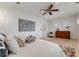 Bright bedroom with light hardwood floors, a ceiling fan, and elegant decor features a modern style at 1609 S Clayton St, Denver, CO 80210