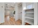 Spacious walk-in closet with built-in shelving and ample storage, adjacent to a well-lit hallway at 1609 S Clayton St, Denver, CO 80210