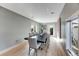 Spacious dining room with modern lighting, large table, and outdoor access at 1609 S Clayton St, Denver, CO 80210