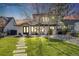 Charming two-story home with a well-maintained lawn and stone pathway, blending classic and modern design at 1609 S Clayton St, Denver, CO 80210