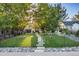 Landscaped front yard with stone pathway and iron fence, enhancing the property's curb appeal. Sign visible at 1609 S Clayton St, Denver, CO 80210