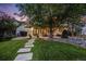 Beautifully landscaped front yard with stone pathway leading to the house, showcasing curb appeal at 1609 S Clayton St, Denver, CO 80210