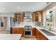 Well-equipped kitchen featuring stainless steel appliances, quartz countertops, and custom cabinetry. Wolf stove at 1609 S Clayton St, Denver, CO 80210