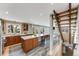 Bright kitchen features modern appliances, marble countertops, and an island with a built-in wine cooler and staircase at 1609 S Clayton St, Denver, CO 80210