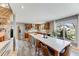 Modern kitchen with stainless steel appliances, a large island with seating, and ample natural light at 1609 S Clayton St, Denver, CO 80210