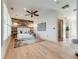 Main bedroom features light wood floors, a wood accent wall, and contemporary decor at 1609 S Clayton St, Denver, CO 80210