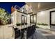 Stylish back patio featuring a large dining table, modern chairs, and covered pergola near building at 1609 S Clayton St, Denver, CO 80210