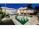 Backyard view showcasing a sparkling pool with a waterfall feature, surrounded by outdoor seating areas at 1609 S Clayton St, Denver, CO 80210
