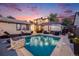 Stunning backyard pool area with lounge seating, an outdoor dining set, and lush landscaping, perfect for entertaining at 1609 S Clayton St, Denver, CO 80210