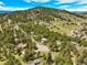 Breathtaking aerial view of a community nestled among lush green trees and rolling hills at 997 Dogwood Dr, Golden, CO 80401