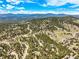 Stunning aerial view showcasing mountain homes surrounded by picturesque landscapes and a clear blue sky at 997 Dogwood Dr, Golden, CO 80401