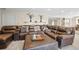 Relaxing basement living room area featuring a large brown leather sectional and decorative shelves at 997 Dogwood Dr, Golden, CO 80401