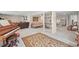 Carpeted basement with a piano, seating, and desk space, offering versatile living options at 997 Dogwood Dr, Golden, CO 80401