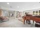 Spacious carpeted basement featuring a piano, sitting area, and built-in shelving at 997 Dogwood Dr, Golden, CO 80401