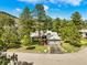 Charming single-Gathering home featuring an attached garage and basketball hoop surrounded by mature trees at 997 Dogwood Dr, Golden, CO 80401