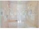 Updated shower with glass door, built-in seating, and multiple shower heads at 997 Dogwood Dr, Golden, CO 80401