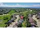 Stunning aerial view of neighborhood, showcasing lush green spaces and mountain views in the distance at 7329 Arco Iris Ln, Castle Pines, CO 80108