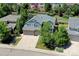 Aerial view of home with a three-car garage and lush green yard at 7329 Arco Iris Ln, Castle Pines, CO 80108
