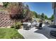 Backyard patio with outdoor seating surrounded by lush landscaping at 7329 Arco Iris Ln, Castle Pines, CO 80108