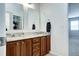 Bright bathroom showcasing a double vanity with granite countertops and wooden cabinetry, ample room for daily routines at 7329 Arco Iris Ln, Castle Pines, CO 80108