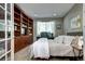 Comfortable bedroom featuring custom built-ins, a dedicated desk space, and soft, natural lighting at 7329 Arco Iris Ln, Castle Pines, CO 80108