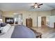 Comfortable bedroom shows wood floors, a fireplace, dresser, and access to an upstairs hallway at 7329 Arco Iris Ln, Castle Pines, CO 80108