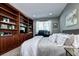 Comfortable bedroom featuring custom built-ins, a dedicated desk space, and soft, natural lighting at 7329 Arco Iris Ln, Castle Pines, CO 80108