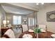 Cozy dining area adjacent to the living room, features hardwood floors and ample natural light at 7329 Arco Iris Ln, Castle Pines, CO 80108