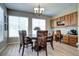 Formal dining room with wood flooring, chandelier, and large windows at 7329 Arco Iris Ln, Castle Pines, CO 80108