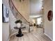 Elegant foyer featuring a curved staircase with iron railing, hardwood floors, and views to the living room at 7329 Arco Iris Ln, Castle Pines, CO 80108