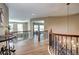 Upstairs hallway shows access to other rooms, with decorative lighting and iron railings at 7329 Arco Iris Ln, Castle Pines, CO 80108