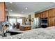Gourmet kitchen featuring an island, breakfast nook, and granite countertops at 7329 Arco Iris Ln, Castle Pines, CO 80108