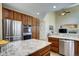 Open-concept kitchen with island, stainless steel appliances, and wood cabinets at 7329 Arco Iris Ln, Castle Pines, CO 80108