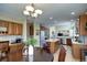 Open layout kitchen with island, and dining area at 7329 Arco Iris Ln, Castle Pines, CO 80108