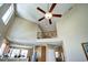Sun-filled living room showcases an open floor plan, with a high ceiling, adjacent to the kitchen and dining areas at 7329 Arco Iris Ln, Castle Pines, CO 80108