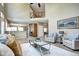 Open-concept living room with view to a gourmet kitchen and a stylish staircase at 7329 Arco Iris Ln, Castle Pines, CO 80108