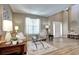 Bright and airy living room boasts hardwood floors, neutral tones, and a seamless flow to the home's entrance at 7329 Arco Iris Ln, Castle Pines, CO 80108