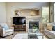 Cozy living room featuring a fireplace, large screen TV, and comfortable seating at 7329 Arco Iris Ln, Castle Pines, CO 80108