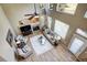 Bright, soaring living room with fireplace, neutral decor, ceiling fan, and large windows at 7329 Arco Iris Ln, Castle Pines, CO 80108